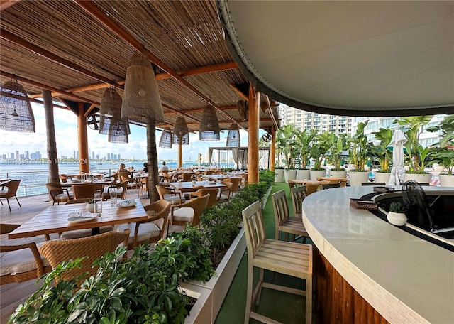 view of patio / terrace with a water view and a bar