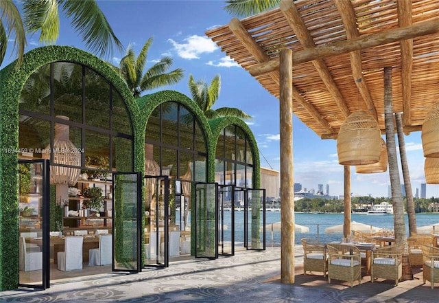 exterior space featuring a water view and a pergola