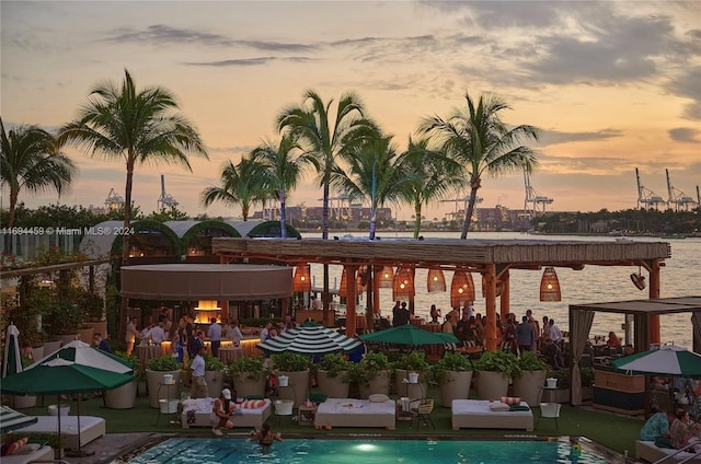 pool at dusk with a water view