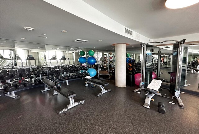 exercise room featuring decorative columns