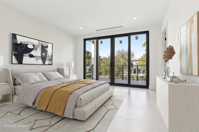 tiled bedroom featuring access to outside, french doors, and expansive windows