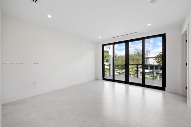 spare room with floor to ceiling windows