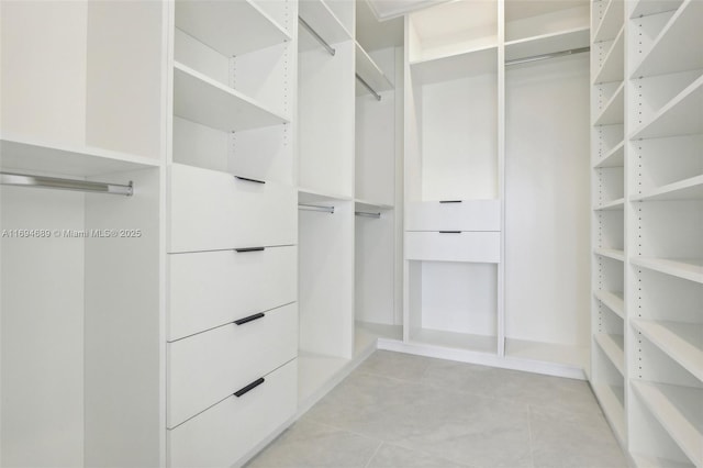 spacious closet with light tile patterned floors