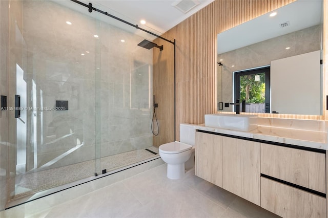 bathroom featuring a shower with door, vanity, tile patterned floors, and toilet