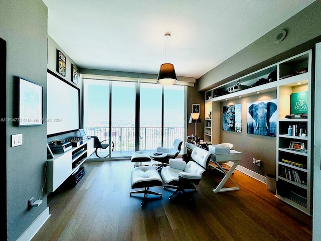 living room with dark hardwood / wood-style floors and a wall of windows