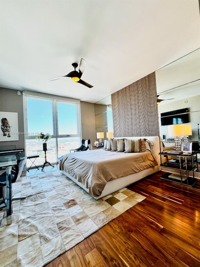 bedroom with hardwood / wood-style flooring and ceiling fan