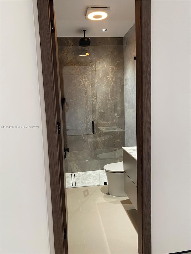 bathroom with walk in shower, tile patterned flooring, vanity, and toilet