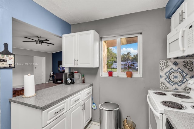 kitchen with white cabinets, ceiling fan, light tile patterned flooring, and white appliances