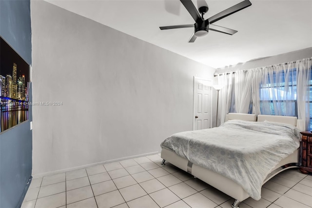 tiled bedroom with ceiling fan