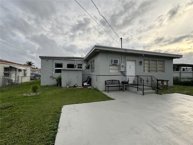 view of front of property with a patio and a front yard