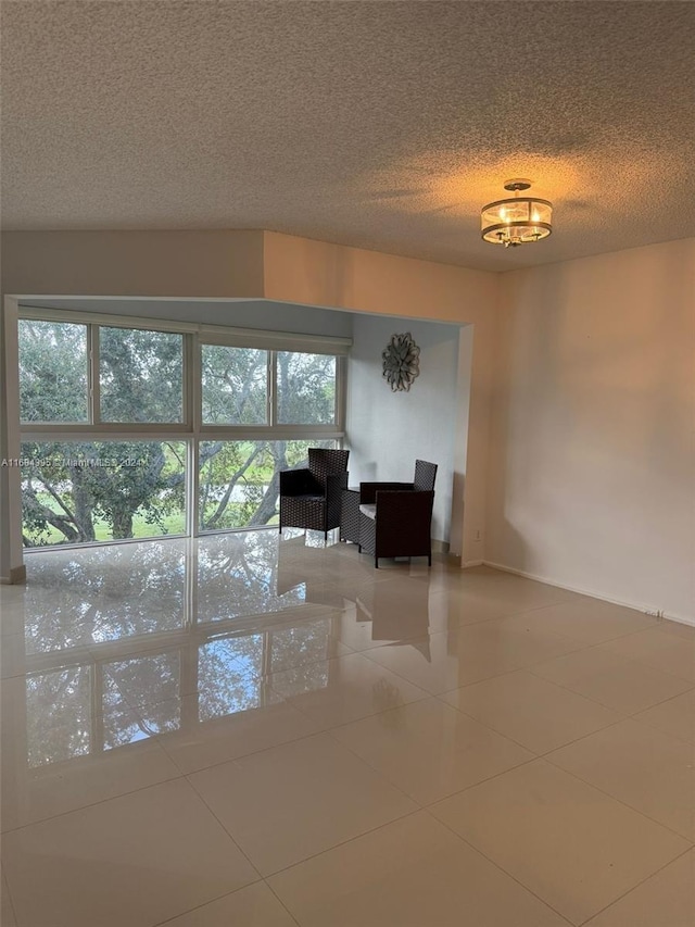 interior space featuring tile patterned flooring and a textured ceiling