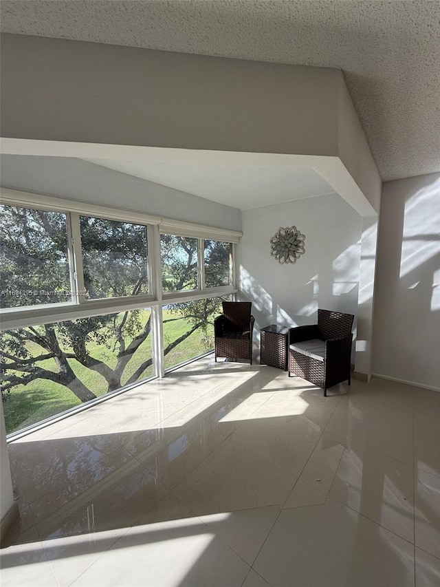 interior space with a textured ceiling and tile patterned floors