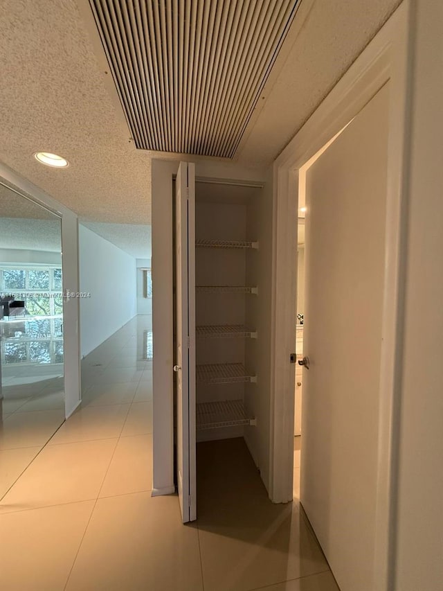 hallway with light tile patterned floors