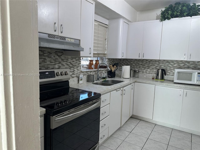 kitchen featuring white cabinets, sink, electric range, decorative backsplash, and light tile patterned floors