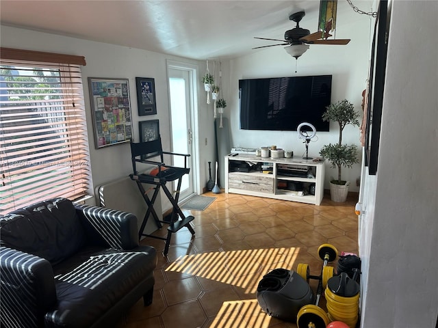 living room with ceiling fan and tile patterned flooring