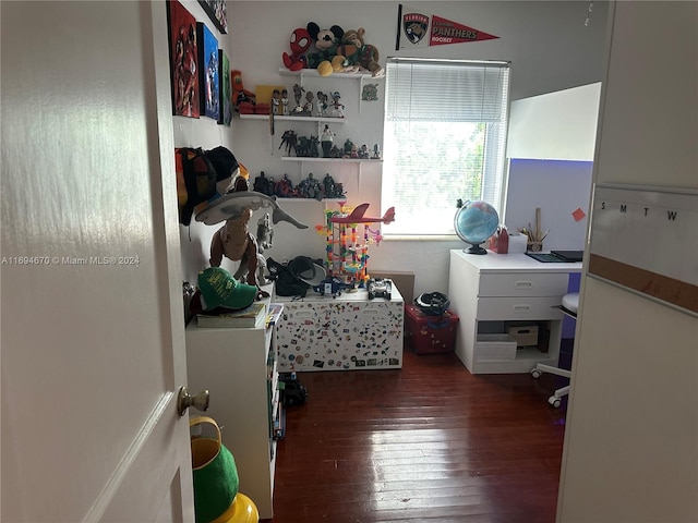 bedroom with dark hardwood / wood-style floors