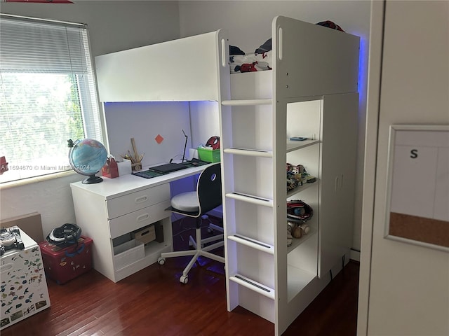 home office with dark wood-type flooring