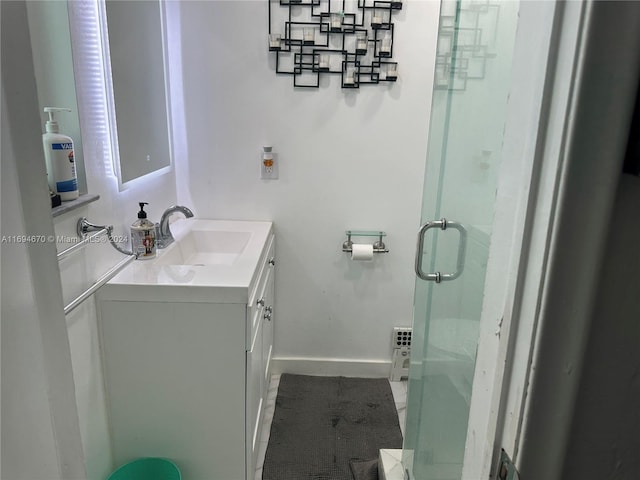 bathroom featuring tile patterned flooring, vanity, and a shower with shower door