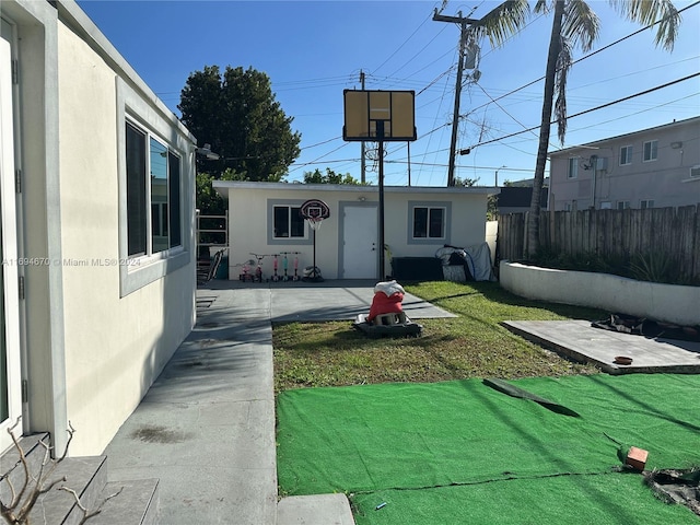 view of yard with an outbuilding and a patio