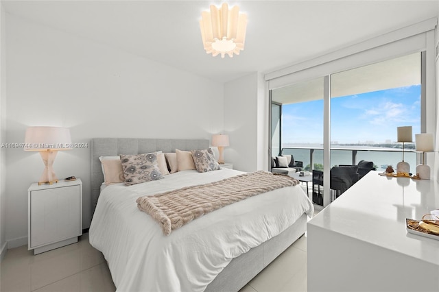 bedroom featuring access to outside, a water view, and light tile patterned floors