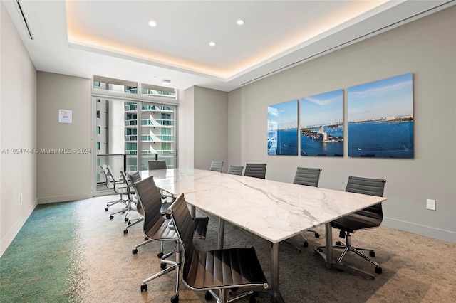 carpeted office with a raised ceiling