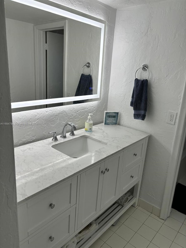 bathroom with tile patterned flooring and vanity