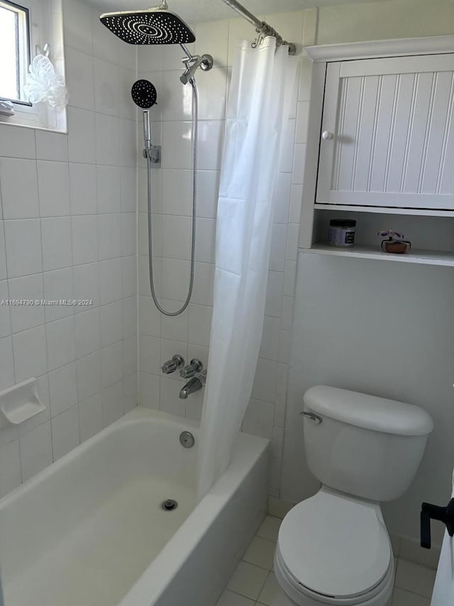 bathroom featuring tile patterned floors, shower / bath combo, and toilet