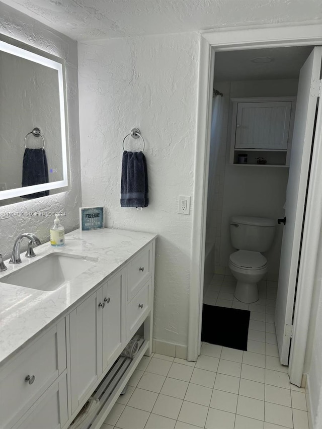 bathroom featuring tile patterned floors, vanity, and toilet