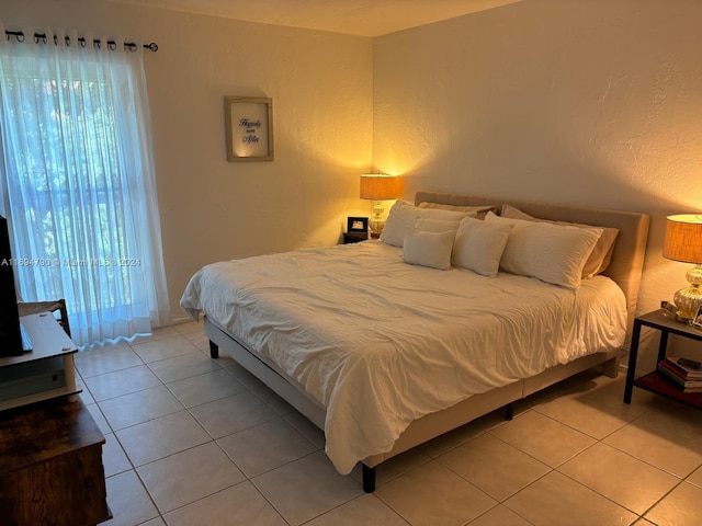 tiled bedroom with multiple windows