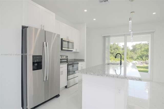 kitchen featuring white cabinets, sink, stainless steel appliances, and hanging light fixtures