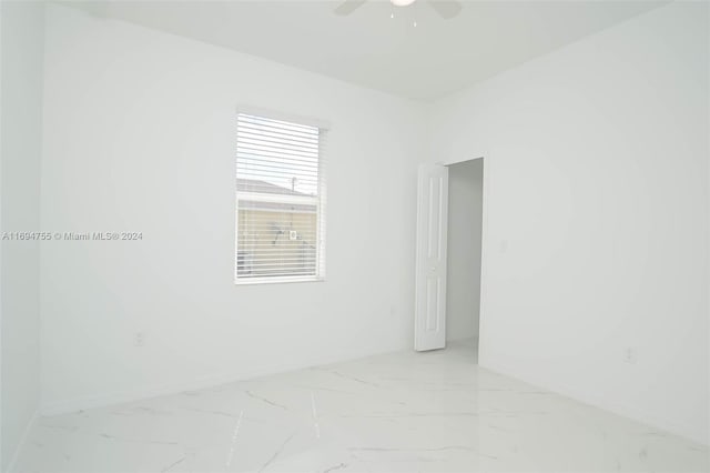 unfurnished room with ceiling fan