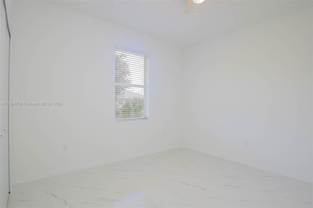 spare room with ceiling fan