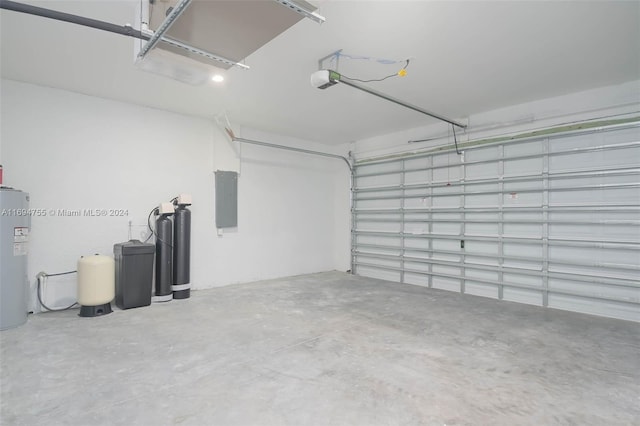 garage featuring electric panel, electric water heater, and a garage door opener