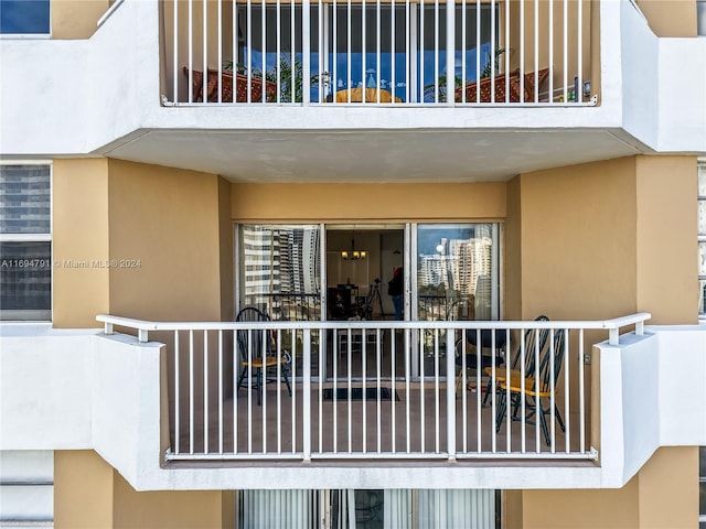 view of exterior entry with a balcony