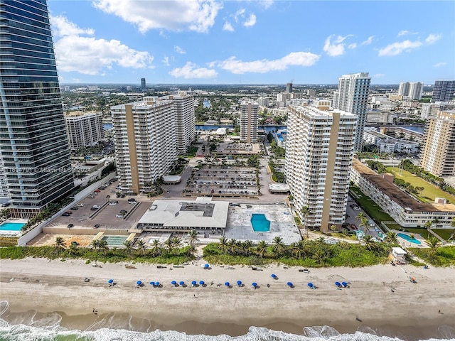 birds eye view of property with a water view and a view of the beach