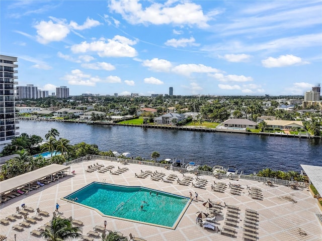 view of pool featuring a patio area and a water view