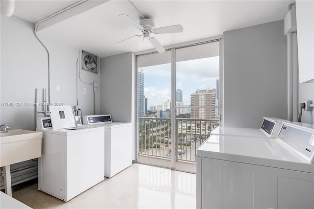 clothes washing area with washer and dryer, ceiling fan, and sink