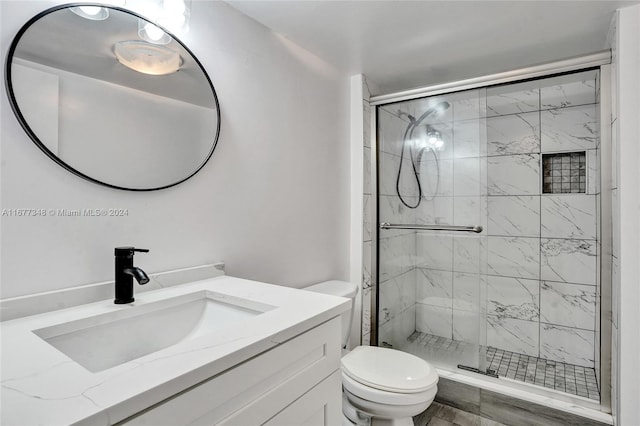 bathroom with vanity, toilet, and walk in shower