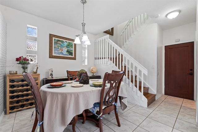 dining room with light tile patterned flooring and stairway