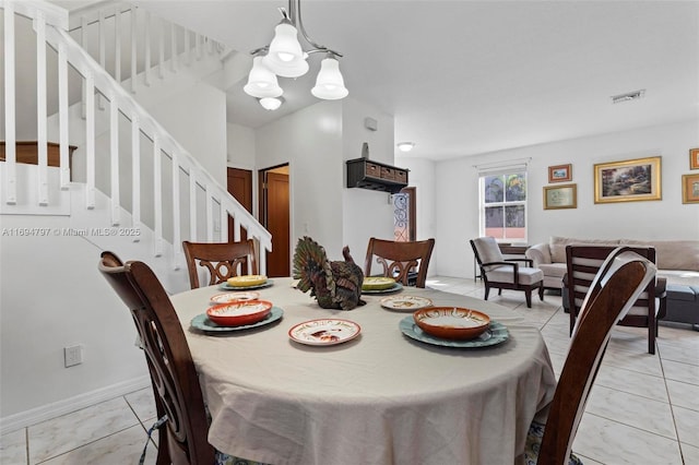 dining space with visible vents, stairway, and light tile patterned flooring