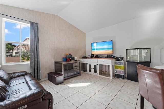 living area with lofted ceiling and light tile patterned floors