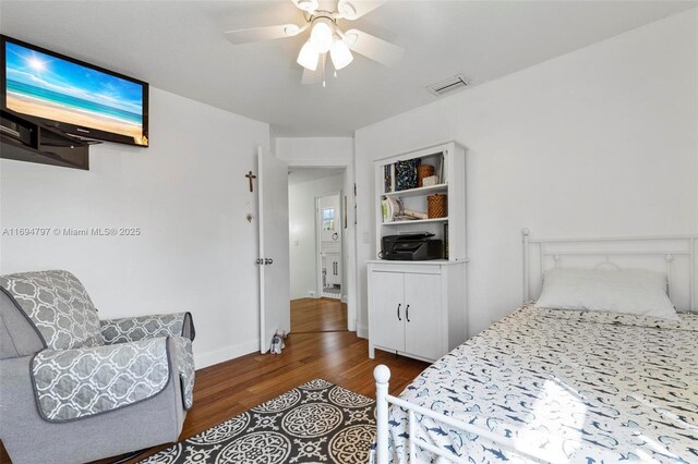 bedroom with a closet, light hardwood / wood-style floors, and ceiling fan