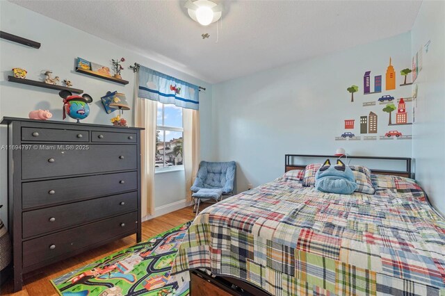 bedroom with a closet and light hardwood / wood-style flooring