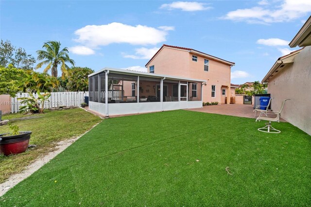 rear view of property featuring a sunroom, a fenced backyard, a patio area, and a lawn