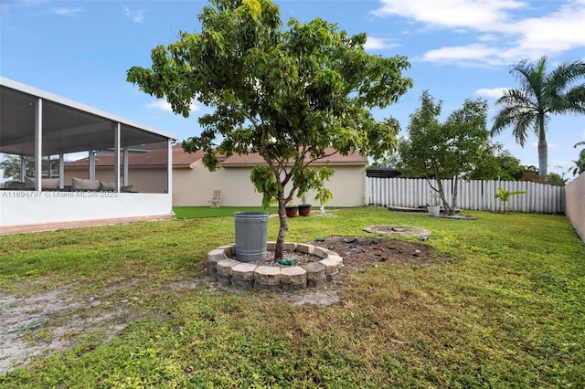 view of yard featuring a fenced backyard and a sunroom