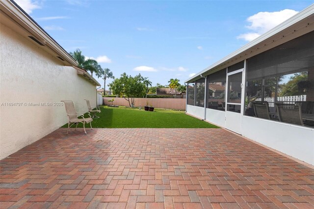 view of patio / terrace with a sunroom and a fenced backyard