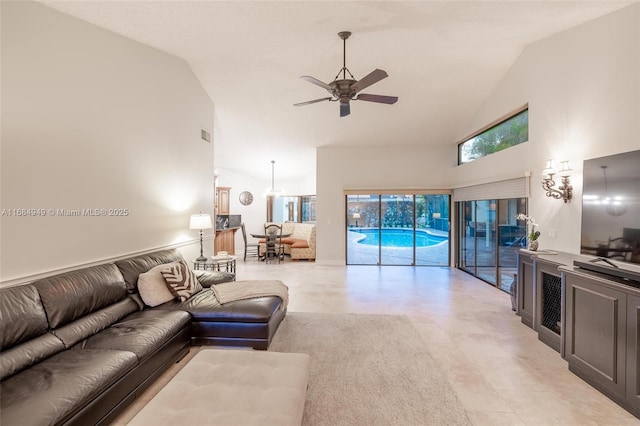 living room with ceiling fan and high vaulted ceiling