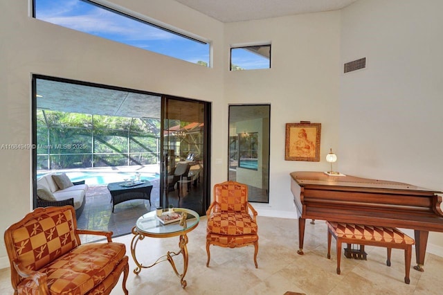 living area featuring a towering ceiling