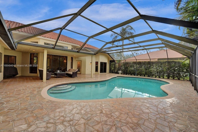 view of pool featuring outdoor lounge area, a patio, and glass enclosure