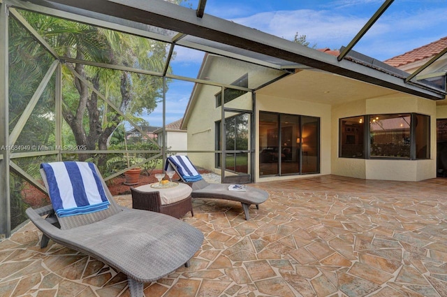 view of patio featuring a lanai